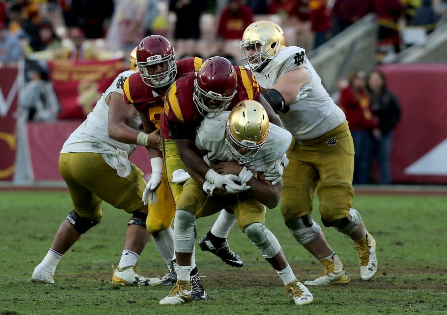 Notre Dame quarterback DeShone Kizer is sacked by USC linebacker Michael Hutchings in the fourth quarter on Saturday, Nov. 26, 2016, at the Los Angeles Memorial Coliseum. USC won, 45-27. (Luis Sinco/Los Angeles Times/TNS)