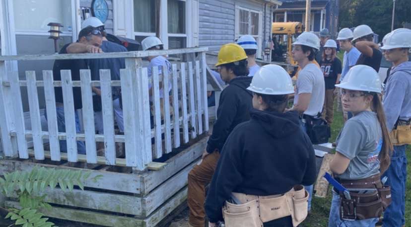 Kallai Sr. helps the carpentry compact work on the porch of one of their recent projects. In the  carpentry compact the seniors build a house in Wadsworth every year.  Photo courtesy of Brandon Sams.