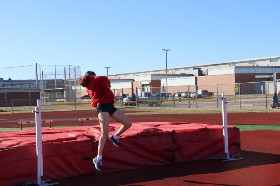 Harris jumps over the bar. Her record height is 410. Photo by Katie Griffin