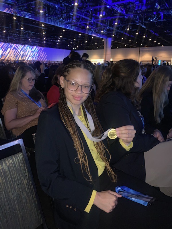 Harris+holds+her+medal+at+ICDC.+She+is+ranked+fourth+in+the+state+of+Ohio+within+her+category.+%0APhoto+courtesy+of+Hailey+Harris.