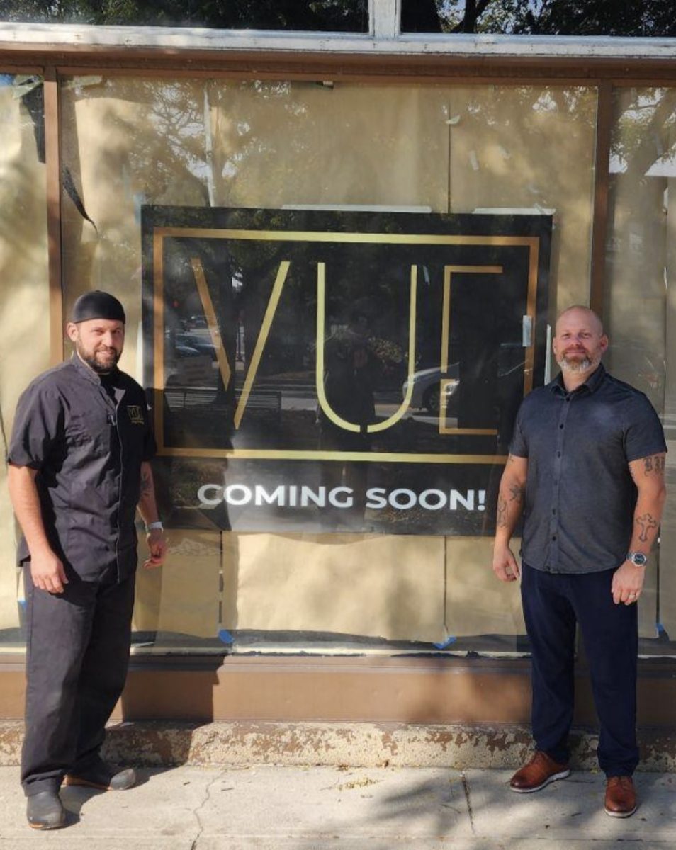 Chef Anthony Scolaro (left) and Brian Dolgowicz(right) stand in front of The Vue with it’s coming soon sign. The Vue will be opening on the northwest corner of the square near the clock. Photo courtesy of Anthony Scolaro.