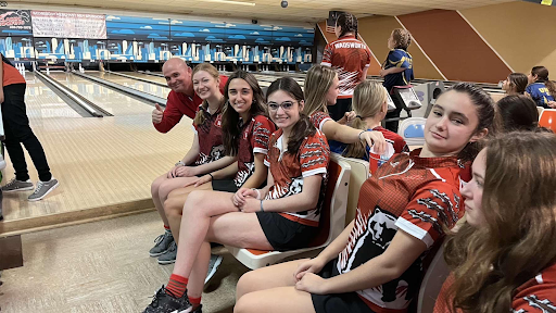 The girls bowling team poses for a photo with the coach. The girls placed sixth in the tournament. Photo by Katie Allen.