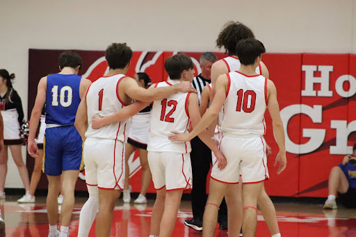 (From left to right)  Maxx Bosley,  Grady Hughes, Finn Schmitt, and Callaghan Corell huddling up before a free throw in the fourth quarter. Hughes is a sophomore and was the third leading scorer for the Grizzlies with 7 points. Photo by Brooke Baughman. 