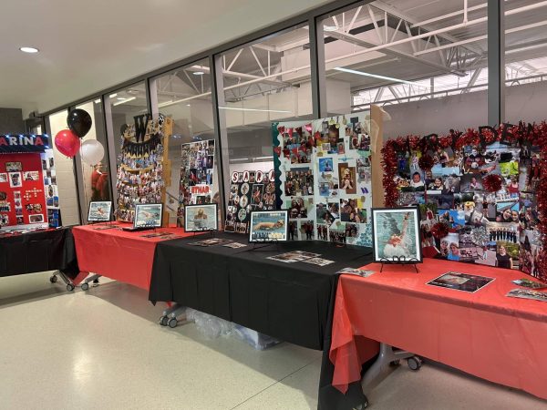 Posters were displayed for all of the seniors with pictures from their years on the swim team. A total of ten swimmers were honored on Senior Night. Photo by Lizzy Edwards.