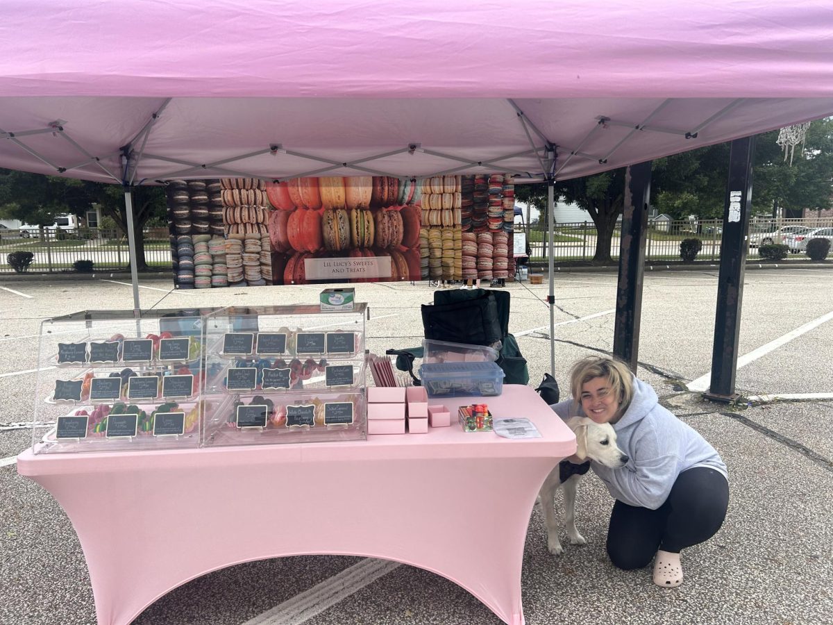 Chrissy Crucioli’s stand at the farmer’s market is shown. Crucioli is accompanied by her dog, Lucy, who is the namesake of her business. Photo by Harper Rosenberger. 
