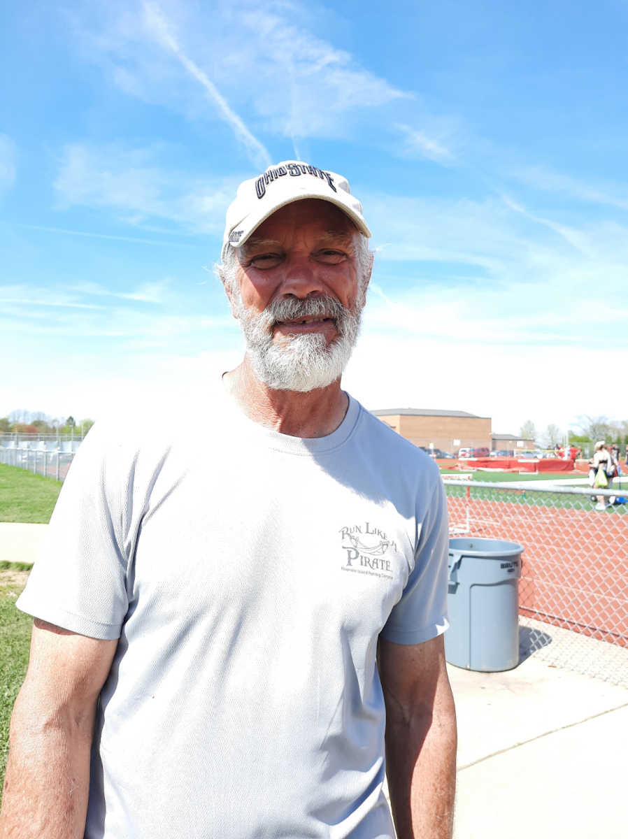 John Burton at a track meet before his retirement as a teacher. He has returned to teach as a long-term substitute. Photo courtesy of Lily Love. 
