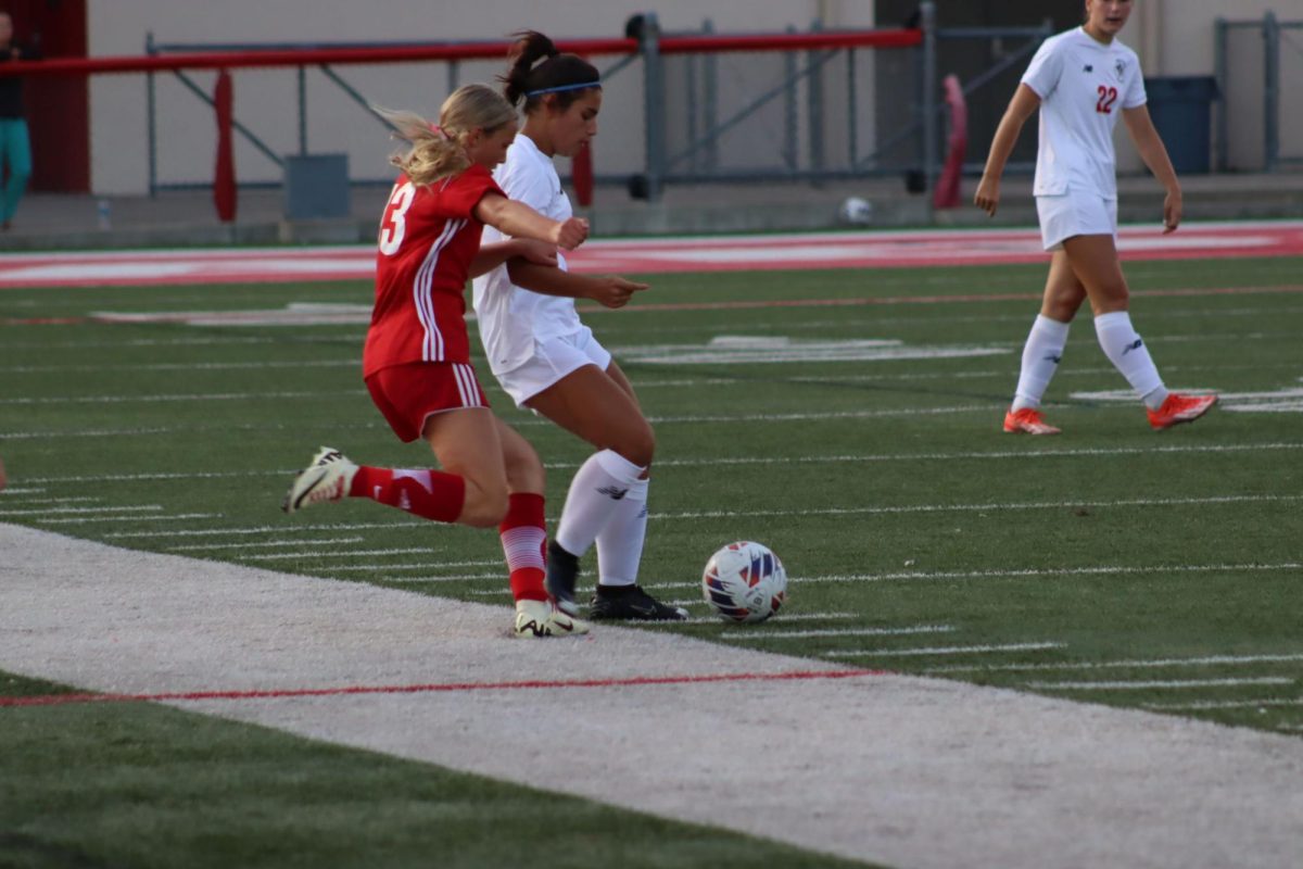 Piper Chadbourne, a Wadsworth midfielder, goes in for a tackle against a Brecksville right defender. Piper stuffed the player and crossed the ball; however, it was intercepted by a Brecksville center-back. Photo by Henry Chen.