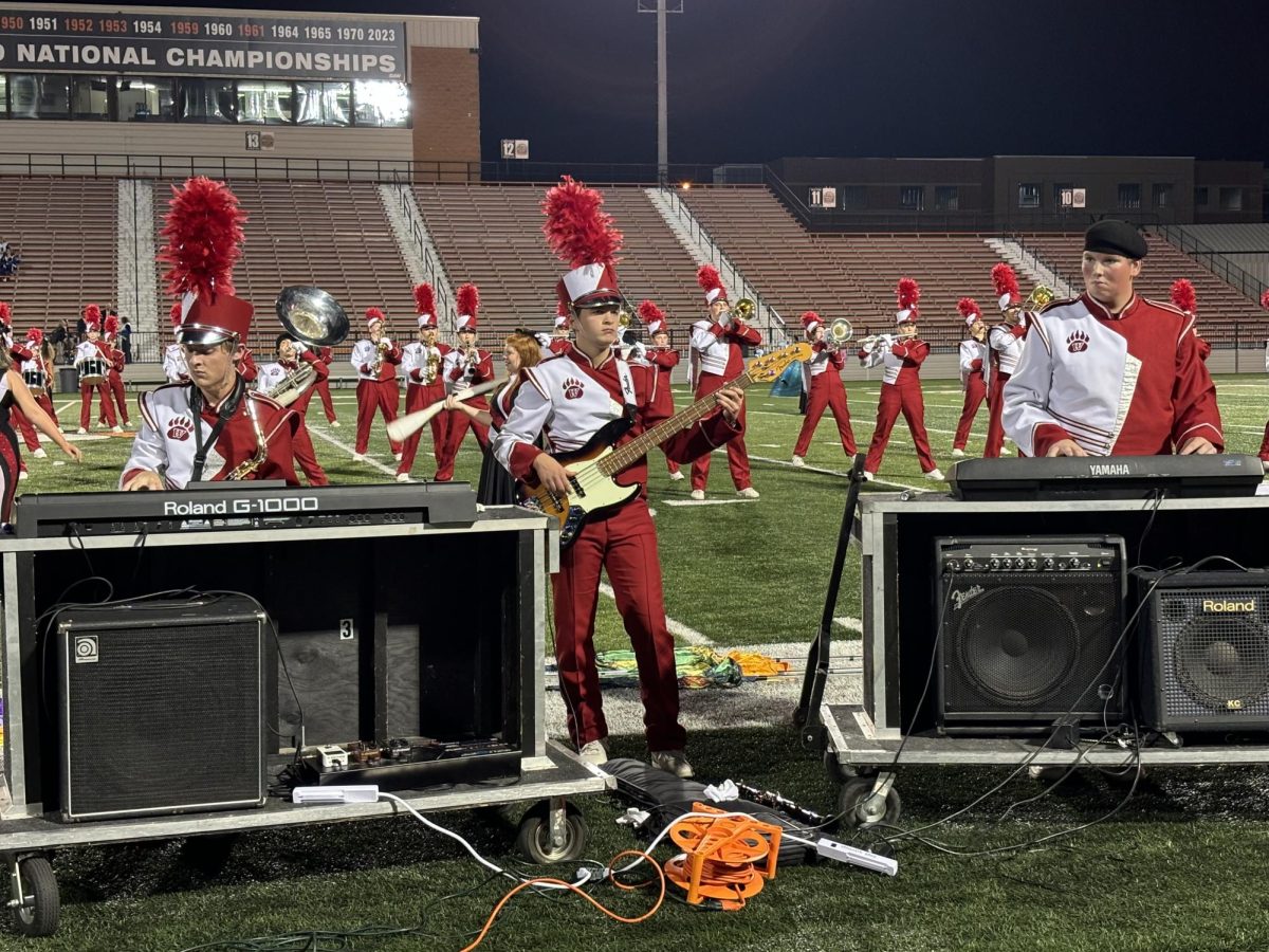 Pictured here is, Matthew Reed, Aiden Mcanalley and Regan Bradley (from left to right) all in uniform with their instruments. All three concentrate at the Massillon band show during song four, we found love. Photo courtesy of Peter Reed. 
