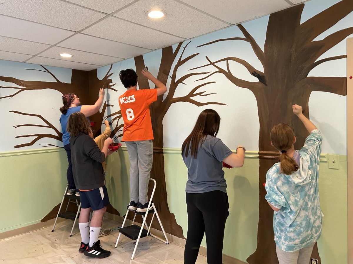 Art club paints trees at Altercares Dementia residents ward. The paint the students used was provided by Altercare. Photo by Liz Allen.