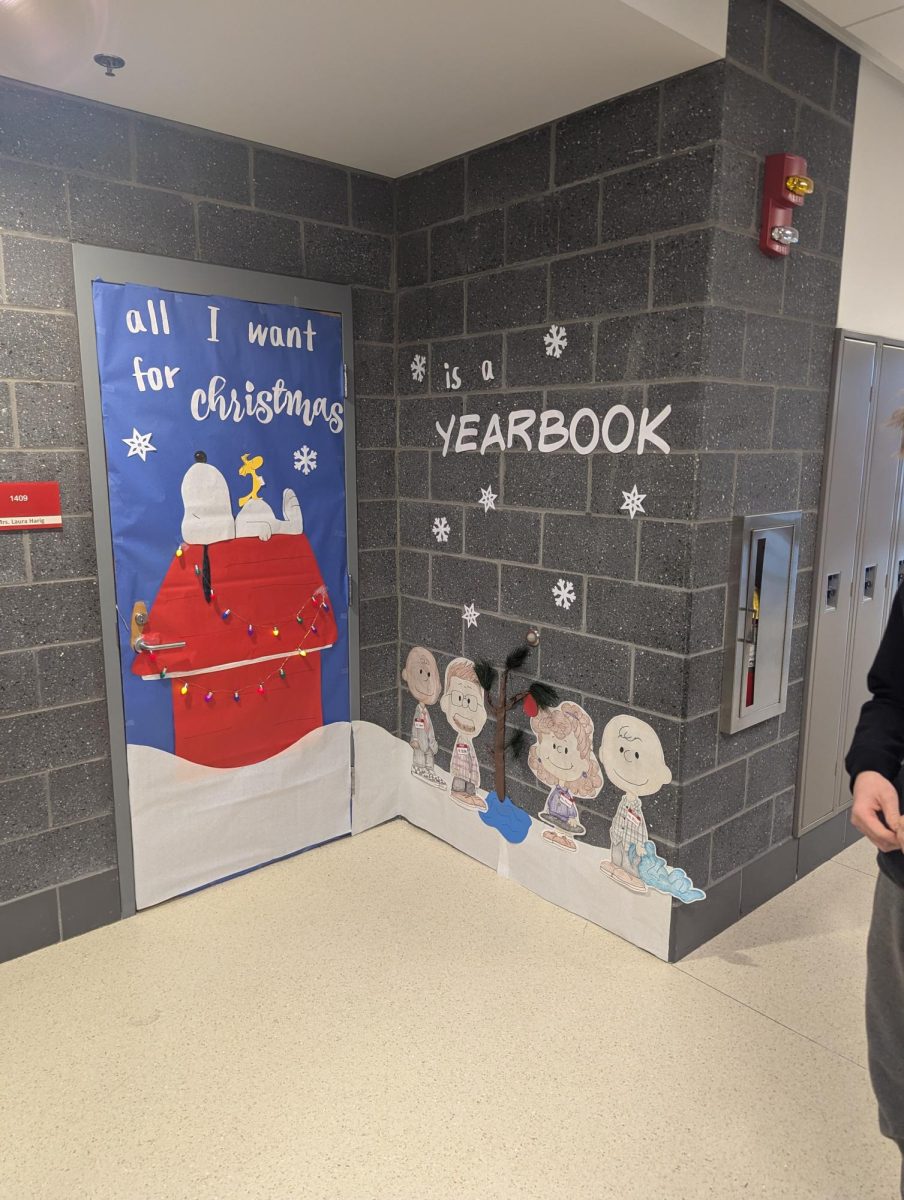 Mrs. Harig’s winning Peanuts themed door. The words on the door make a play on the song All I Want For Christmas by Mariah Carey.