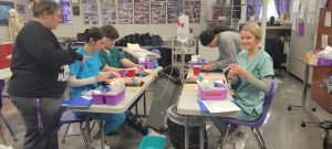 Seniors ATN students are learning how to draw blood on mannequins during class. The students are each tasked with doing 30 live sticks in order to be certified in phlebotomy. Photo courtesy of Reagan Hunt. 