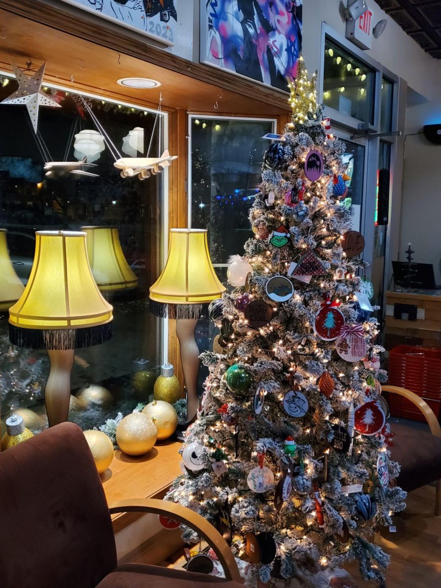 The decoerated window and Christmas Tree in Uniquely Handmade For You is shown. The Kreuzers decorate their store each year for Christmas, as well as First Friday. Photo by Lily Roden. 
