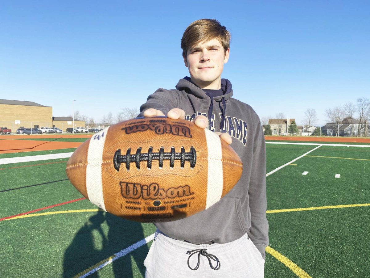 Mitchell Evans posed for a photo with the Bruin in 2020 after announcing that he would be graduating early so that he could start practices with the Notre Dame football team in South Bend, Indiana. 