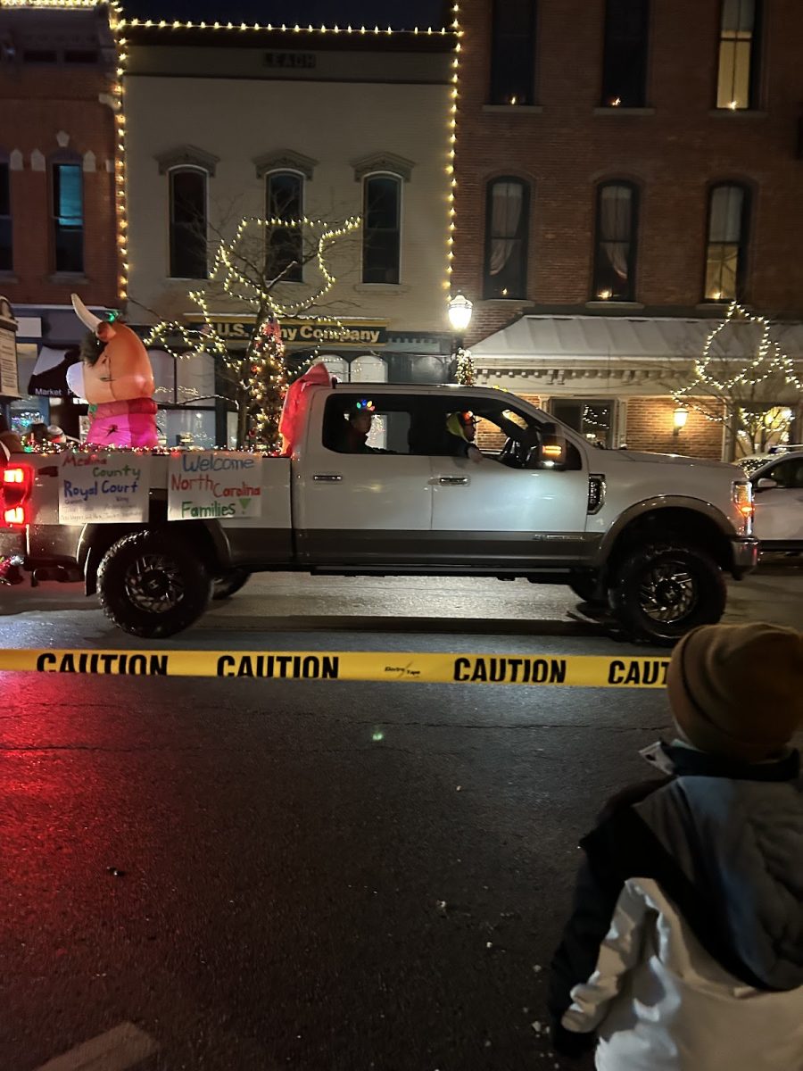 A Medina County Royal Court truck hangs signs that welcome the survivors in the parade on Saturday, Jan. 10. The car gave out candy to spectators. Photo by Liz Allen. 