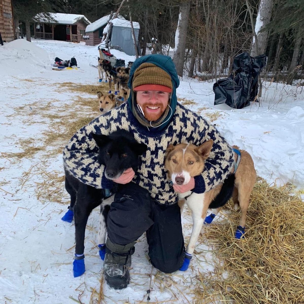 Dane Baker taking a photo with two of the dogs he went mushing with. Support Failor and Dane at www.akhusky.dog which is Failors website. Photo courtesy of Dane Baker.