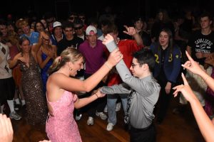 Lillian Mccomas (left) and Matthew Reed (right) are seen dancing in the center of the dance floor.