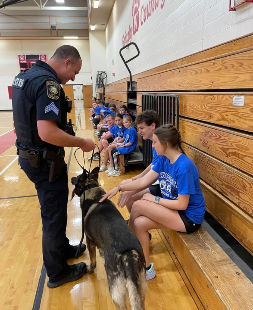 A K-9 handler and an officer are letting the volunteers pet a K-9 dog. The K-9 dog is Zoro and joined in November 2016. Photo courtesy of the Wadsworth Police Instagram.