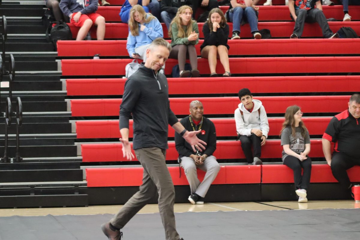 Scott Callaghan walks down to the podium to collect his retirement plaque. This photo was taken of the Fine Arts assembly.