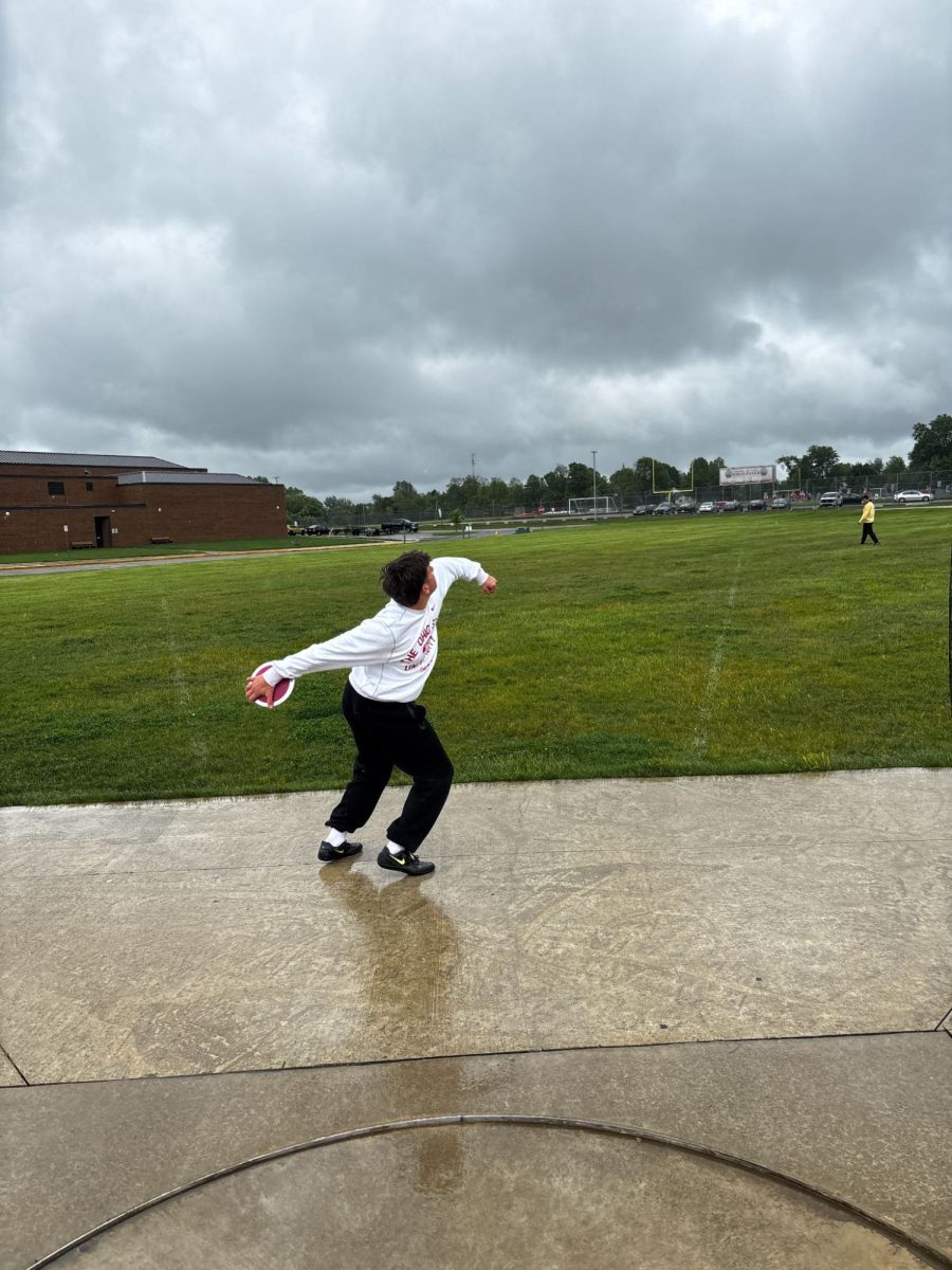 Crosby Haughn prepares to throw the discus during practice with Lincoln Reeling and their coach Sean Neely. This photo was taken on May 22, 2025 during an afterschool practice to prepare them for upcoming competitions.