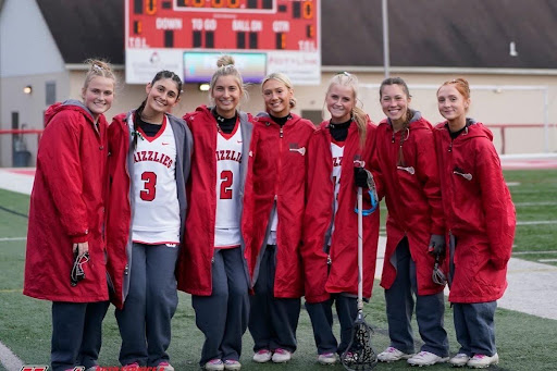 Pictured here is Addy Painting, Kara Dallas, Alivia Lalli, Emma Lynn, Chloe Piekarski, Hailey Patrick and Reagan Riggenbach from left to right. The girls take a picture together in uniform during a game. Photo courtesy of Roger Smith
