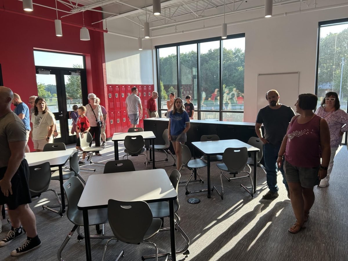 This learning area has a white board and some black cabinets. The door on the left leads to an outside balcony. 