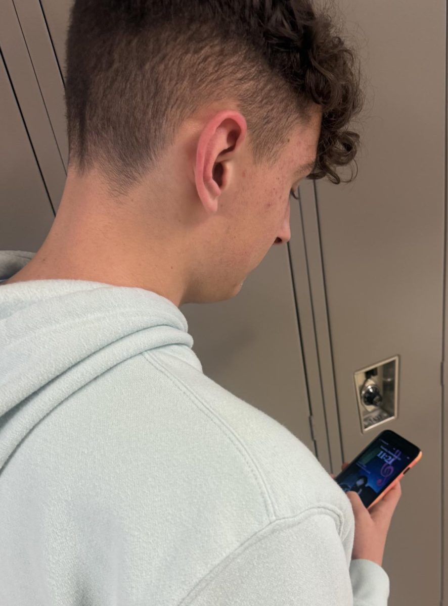 Junior, Drake Fairbanks, on his phone in the hallways at Wadsworth High School. As of right now, you are not allowed to be on your cell phone during the change time in between class periods.