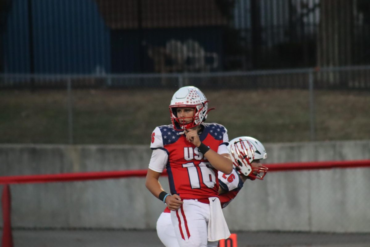 Brysen Hall lines up to snap the ball at the start of a play against Twinsburg. The Grizzlies would go on to win this game 39-0.