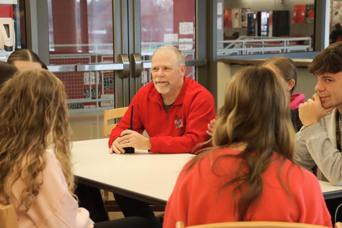 Rich Berlin sitting with students in the Grizzlies Leaders group. Rich Berlin and the students were learning facts about each other. Their meeting was held in the Medina center on Nov. 19th. 