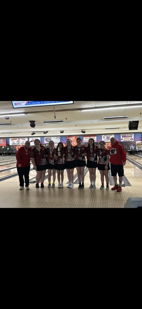 Wadsworth High School's girls' bowling team poses alongside coaches at local bowling alley. The girls' went undefeated all season, with an overall score of 13-0.