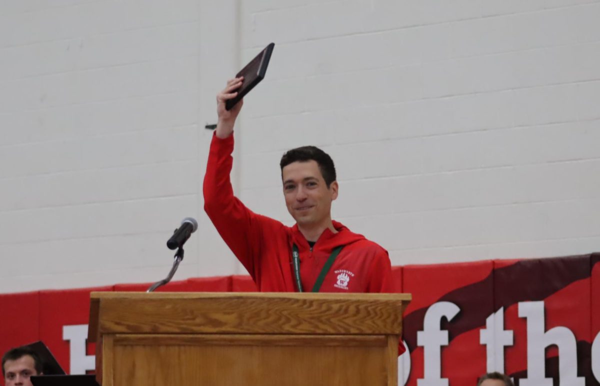 Zach Humrichouser accepts his 2026 Teacher of the Year award. Humrichouser celebrated the win with his family who greeted him after the award was announced. 